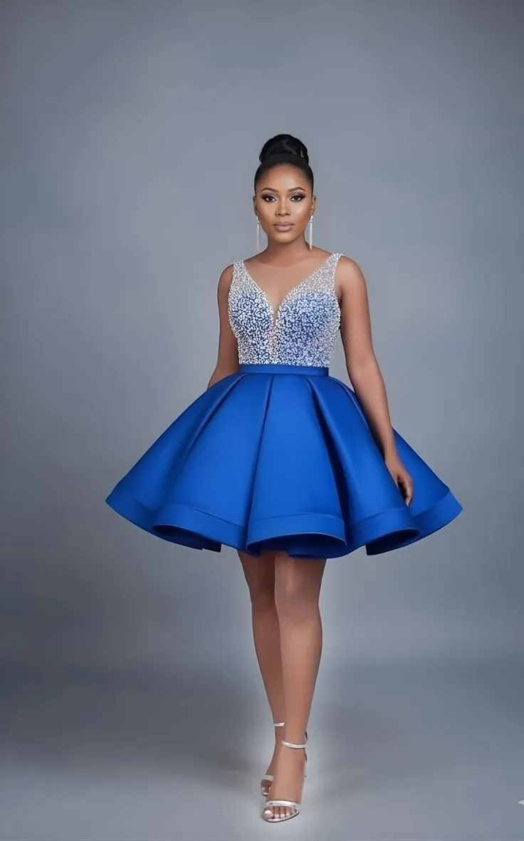 Woman in a cobalt blue cocktail dress with a crystal-embellished bodice and full skirt